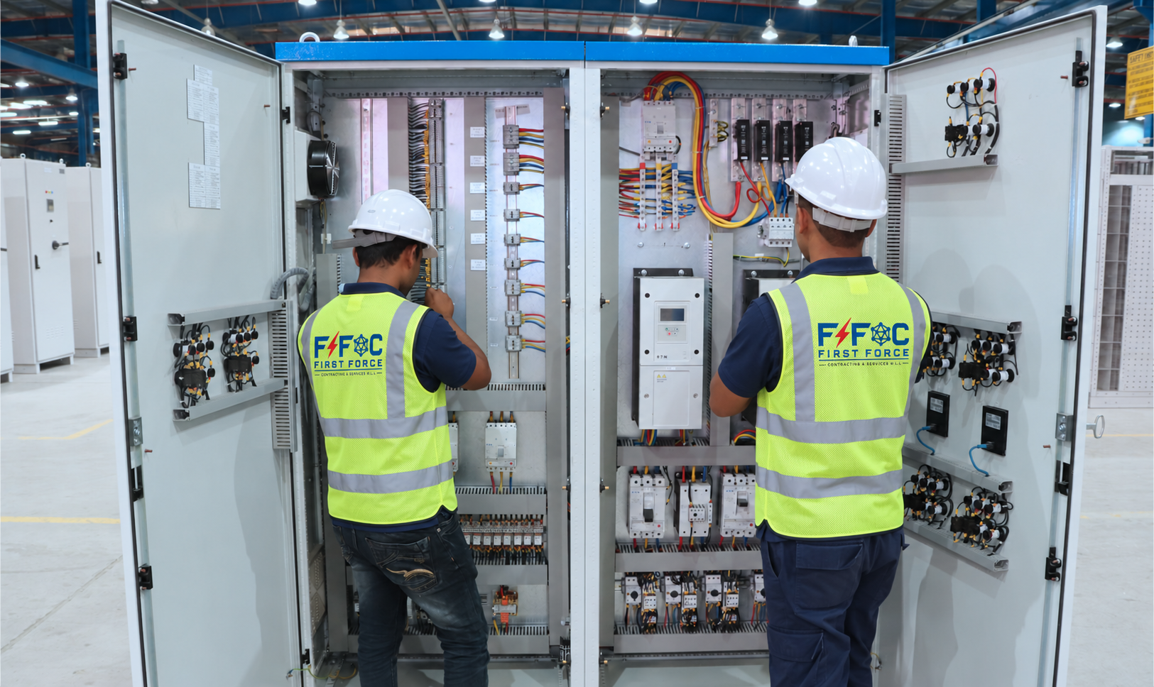First Force engineers working on an electrical panel